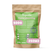 A stand-up kraft paper pouch labeled Organifer Pastel Blooming, with a large green front panel and pink callout badges showing 500G and 250M2.