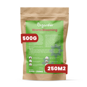 A brown kraft paper stand-up pouch of Organifer Warm Blooming fertilizer, featuring a green label with white text and two red badge overlays indicating '500G' and '250M2'.